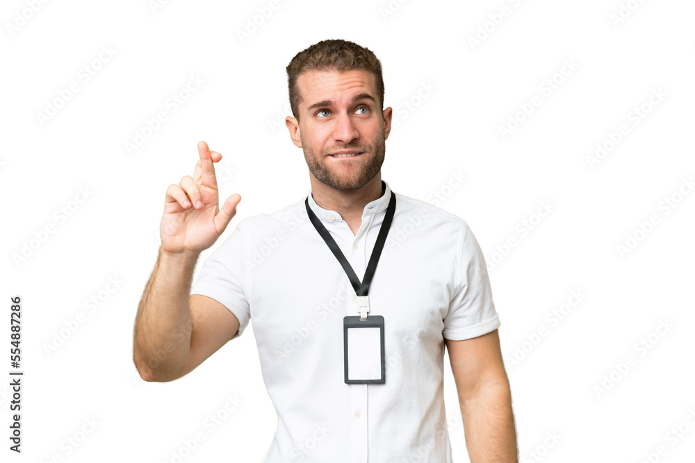 Young caucasian man with ID card isolated on green chroma background with fingers crossing and wishing the best Young caucasian man with ID card isolated on green chroma background with fingers crossing and wishing the best