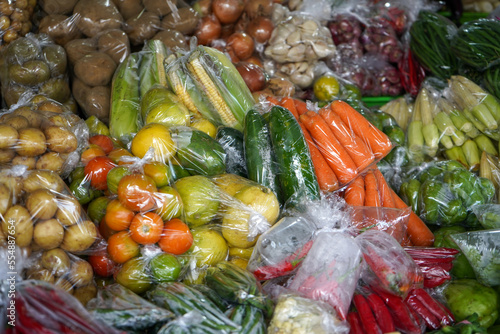 Many eggplants, tomatoes, potatoes, carrots, cucumbers, chilies, red chilies, corn, onions, avocados, chayote, green beans, long beans, garlic are sold in Bandungan Market, Semarang,  Indonesia. photo