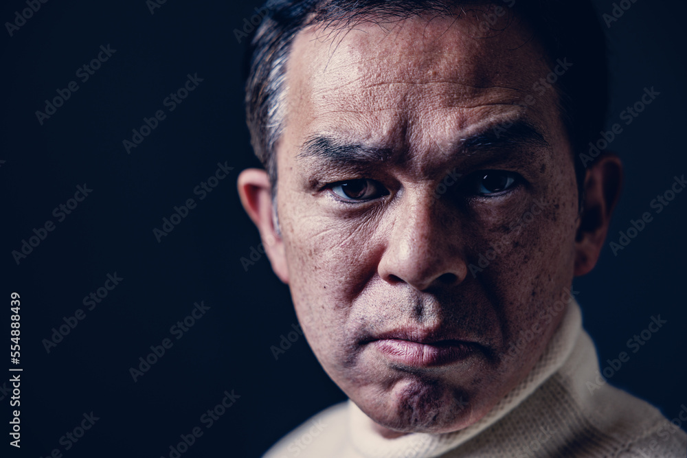 Middle-aged Asian man in white turtleneck wool sweater under black background. Concept image of Warm Biz, stability in daily life, and sustainable living. Middle-aged Asian man in white turtleneck wool sweater under black background. Concept image of Warm Biz, stability in daily life, and sustainable living.