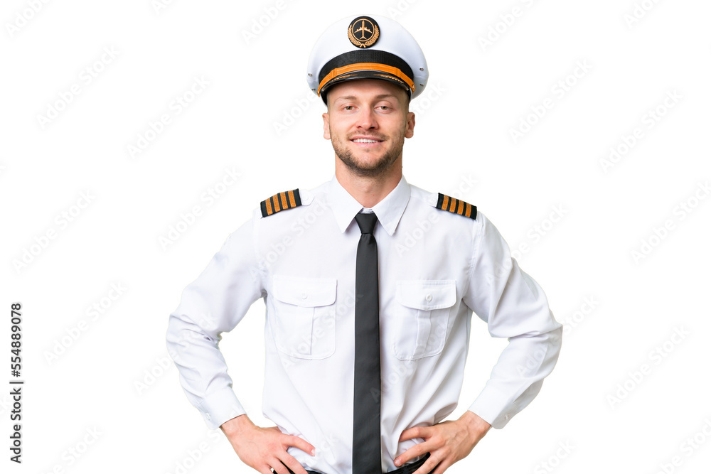 Airplane pilot man over isolated background posing with arms at hip and smiling - obrazy, fototapety, plakaty 