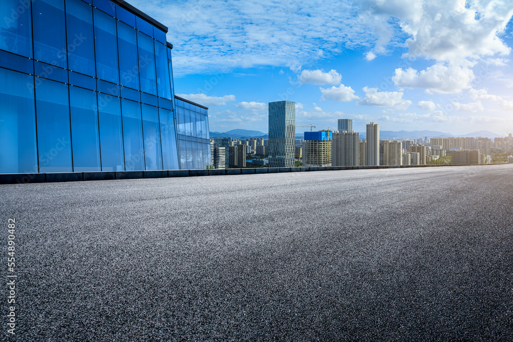 Asphalt road and modern city skyline with buildings in Ningbo, Zhejiang Province, China.