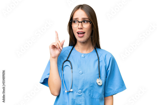 Young nurse caucasian woman over isolated background thinking an idea pointing the finger up