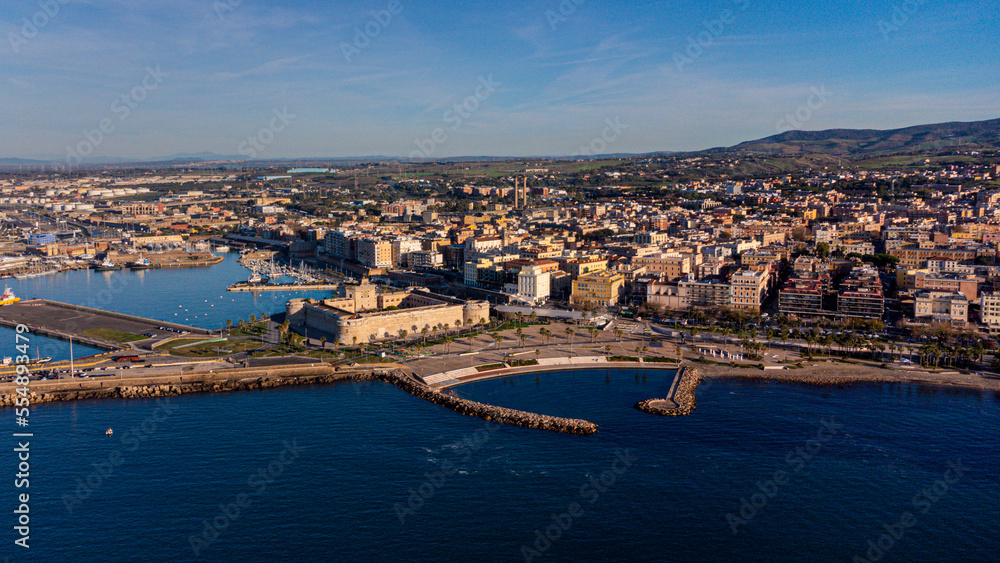 Panoramic view of the city of Civitavecchia with the adjoining tourist port and Forte Michelangelo. Emerald sea and view with tropical palm trees.