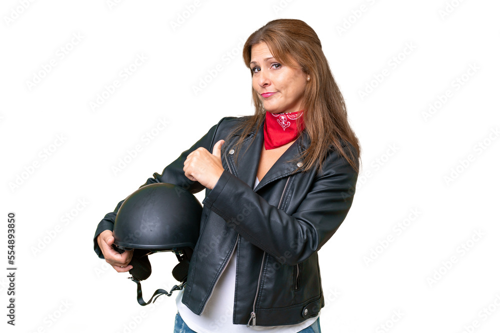 Middle-aged caucasian woman with a motorcycle helmet over isolated background proud and self-satisfied Middle-aged caucasian woman with a motorcycle helmet over isolated background proud and self-satisfied