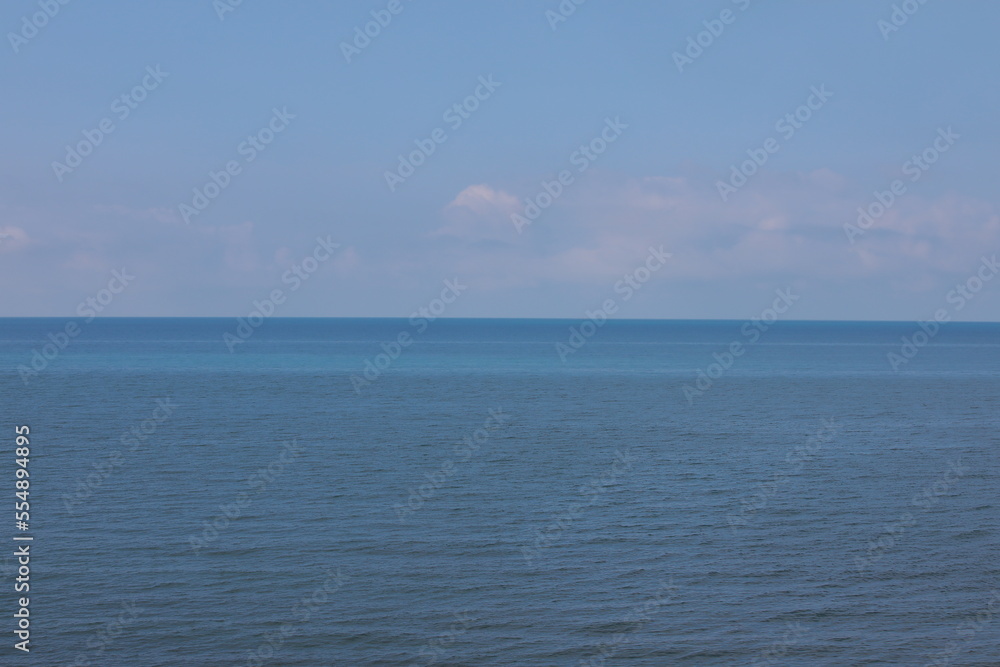 Seascape with blue water and sky on the horizon