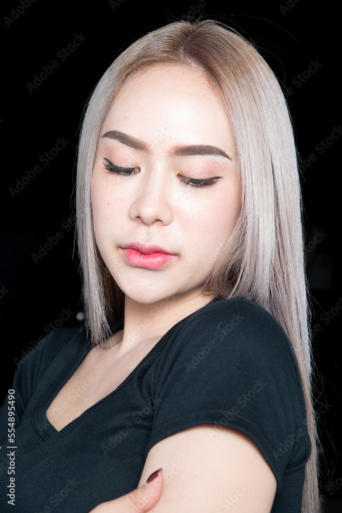 head shot of caucasian beauty girl ashen hair wear black t shirt with studio lighting for cosmatic black background head shot of caucasian beauty girl ashen hair wear black t shirt with studio lighting for cosmatic black background