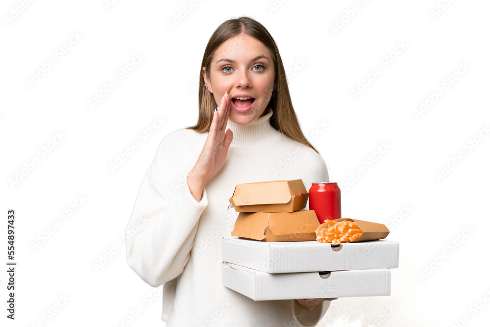 Young beautiful blonde woman holding takeaway food over isolated background with surprise and shocked facial expression Young beautiful blonde woman holding takeaway food over isolated background with surprise and shocked facial expression