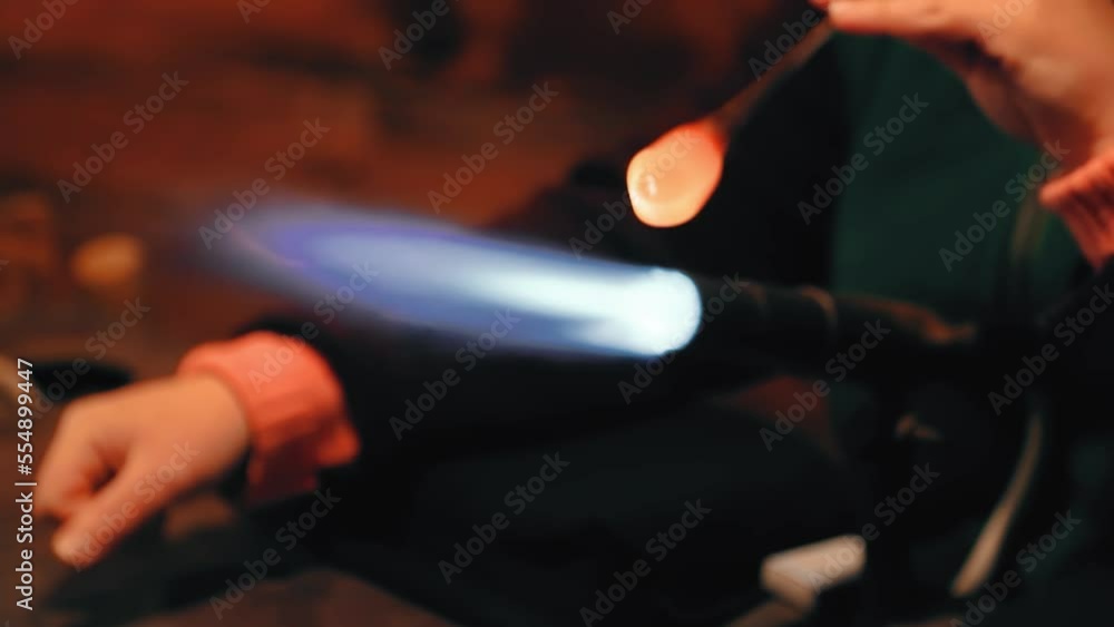 Glass blowing creates a Christmas tree ball. Handmade, craft Christmas toys. A woman blows glass, melts glass with fire. Glass blowing creates a Christmas tree ball. Handmade, craft Christmas toys. A woman blows glass, melts glass with fire.