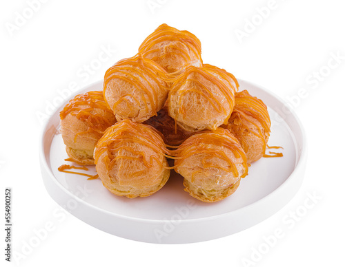 Tasty round eclairs with cream on white background