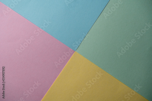 Abstract geometric paper is colorful background. Blue, pink, green and yellow trend colors. Creative design for pastel wallpaper