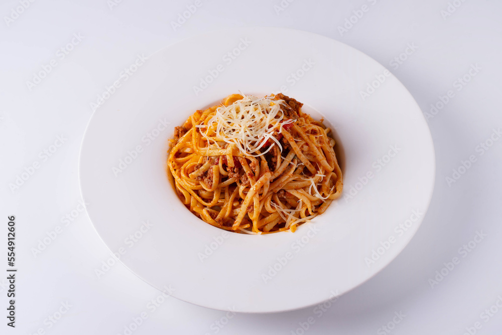 pasta in sauce with cheese on a white background