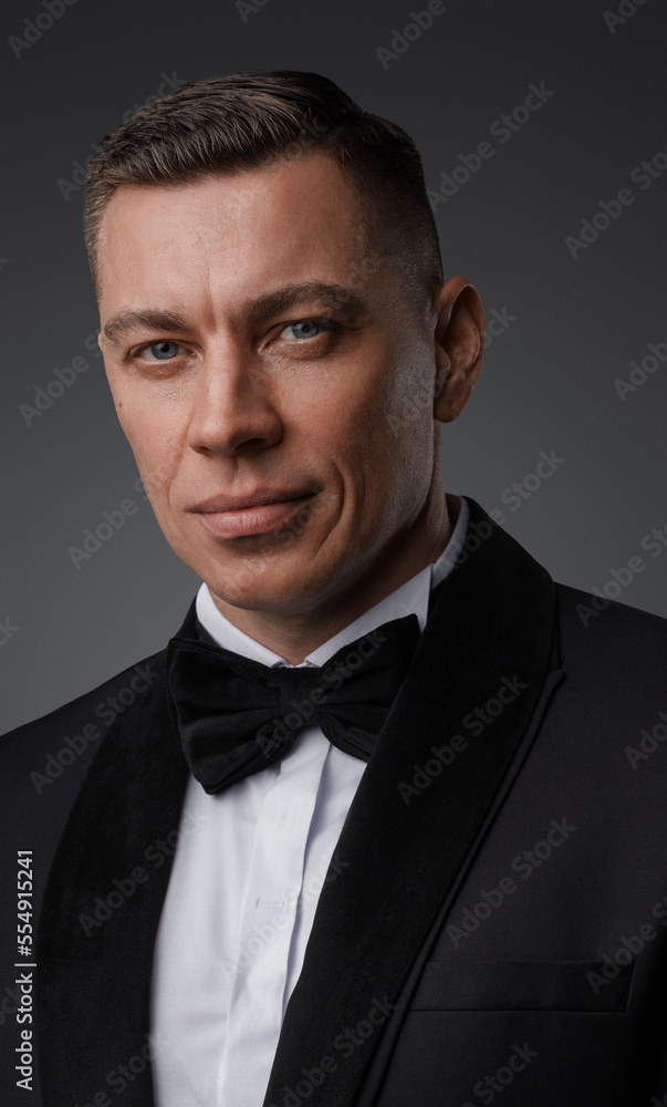 Shot of spy man with bowtie and suit looking at camera. Shot of spy man with bowtie and suit looking at camera.