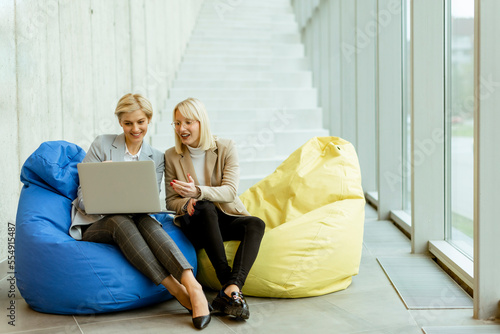 Businesswomen using laptop ...