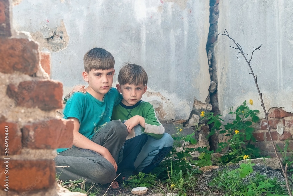 Children in an abandoned house, two poor abandoned boys, orphans as a result of natural disasters and military actions. Submission photo. Children in an abandoned house, two poor abandoned boys, orphans as a result of natural disasters and military actions. Submission photo.