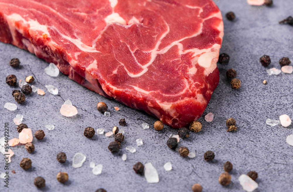 Fresh beef steak on a concrete background