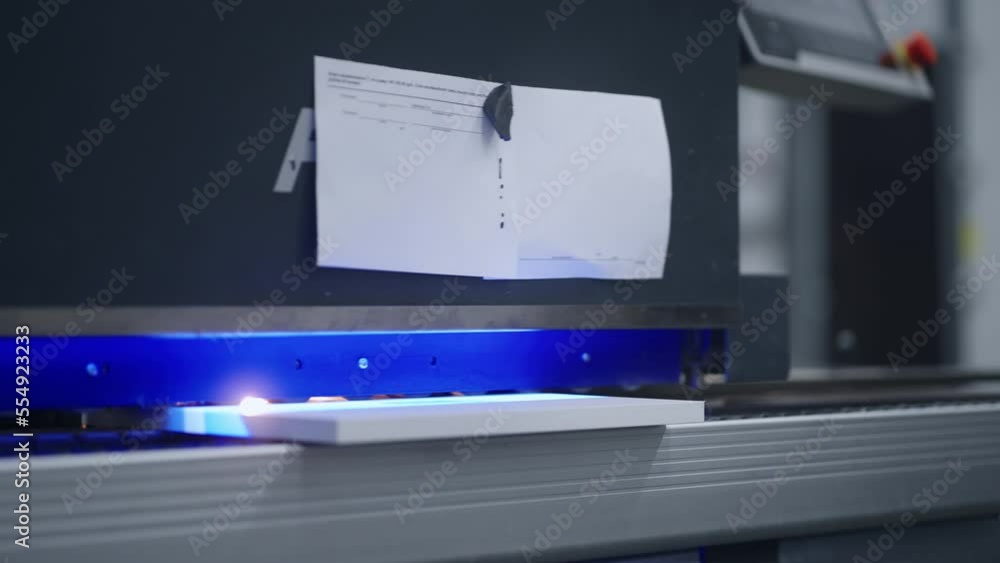 automated woodworking process, worker puts chipboard detail in edge banding machine, closeup automated woodworking process, worker puts chipboard detail in edge banding machine, closeup