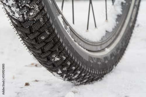 Winter tires with studs, safe cycling in the cold season when snow and ice cover the roads.