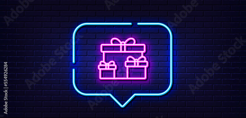 Neon light speech bubble. Gift boxes line icon. Present or Sale sign. Birthday Shopping symbol. Package in Gift Wrap. Neon light background. Surprise boxes glow line. Brick wall banner. Vector