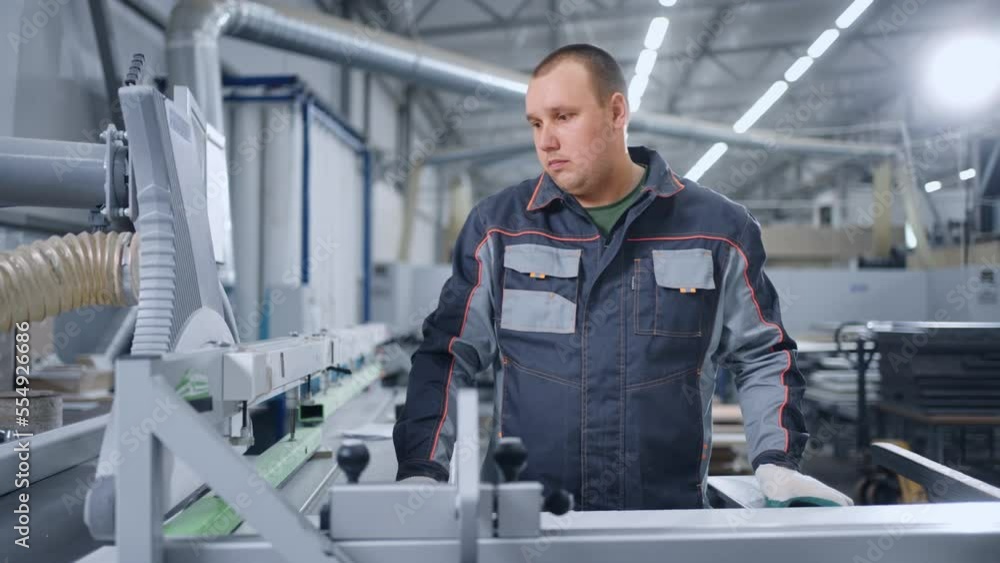 laborer is working in workshop of modern furniture factory, portrait of adult man in uniform laborer is working in workshop of modern furniture factory, portrait of adult man in uniform