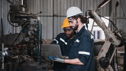 Fotografie Industrial engineers inspect and perform maintenance on the machines at factory machines