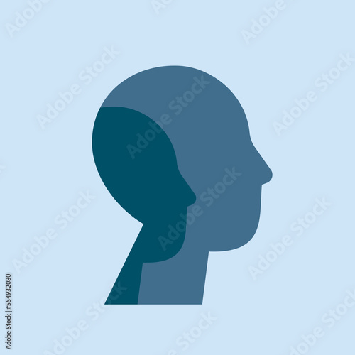 Psychology of personality disorders concept. Male silhouette with two faces on a blue background