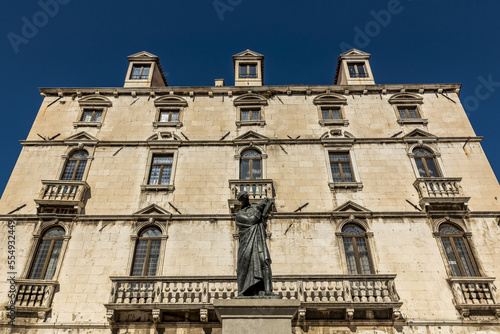 Statue of Marko Marulic, father of Croatian literature, by Ivan Mestrovic in front of the Milesi Palace in Fruit Square; Split, Croatia photo