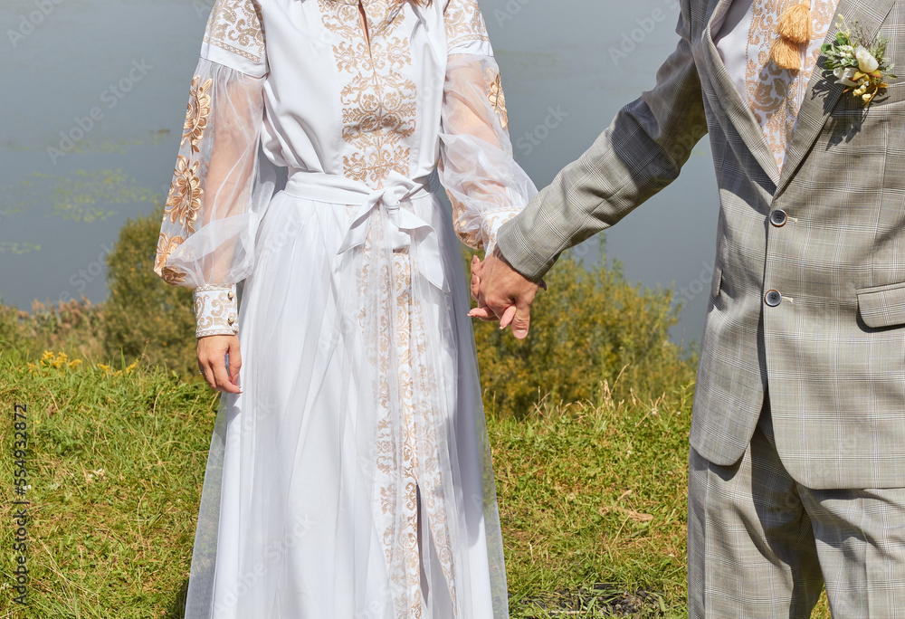 Newlyweds are holding hands. Wedding style. Love of bride and groom hands. 