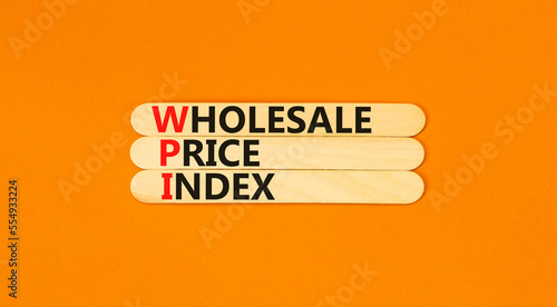 WPI wholesale price index symbol. Concept words WPI wholesale price index on wooden sticks on beautiful orange table orange background. Business WPI wholesale price index concept. Copy space.