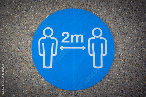 Physical distancing marker on sidewalk reminding to keep a safe space of two meters (6 feet), Covid-19 World Pandemic; London, England photo