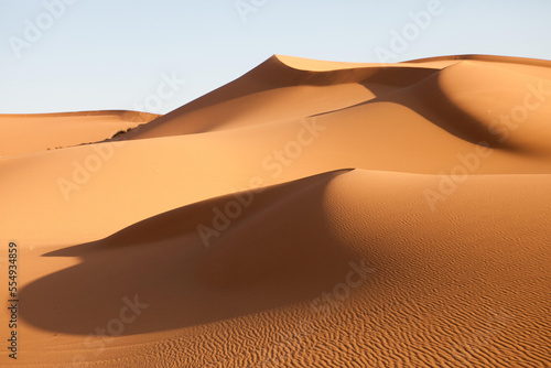 Sand dunes in the Sahara desert are illiminated in soft light.; Erg Chebbi , Sahara Desert , Morocco photo