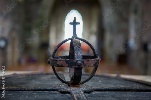 An iron sculpture and cross stands at the entrance of the Benedictine Abbey in Iona, Scotland; Iona, Isle of Iona, Scotland photo