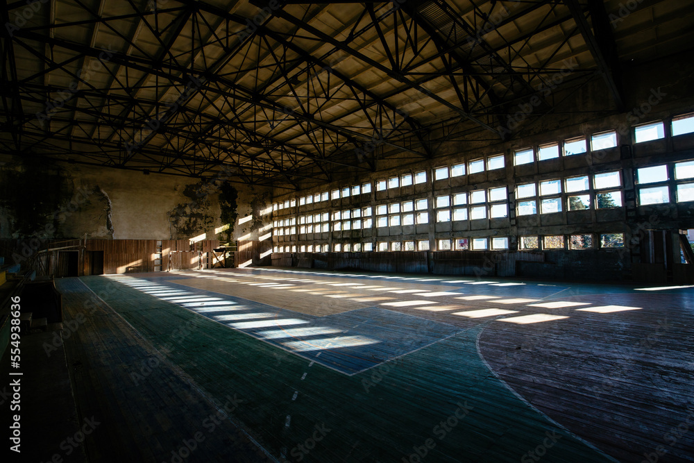 Large old ruined gymnasium in abandoned school