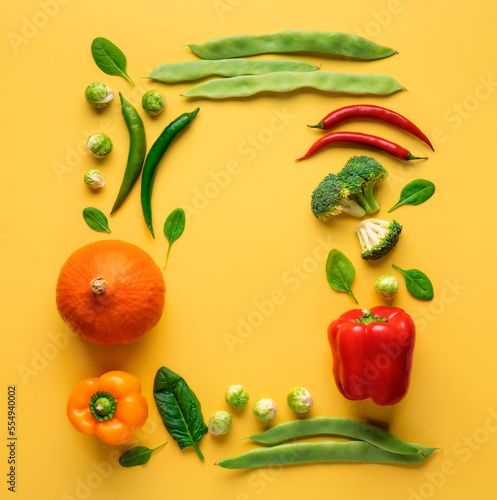 Frame of set of various vegetables for healthy and diet food on a yellow background top view