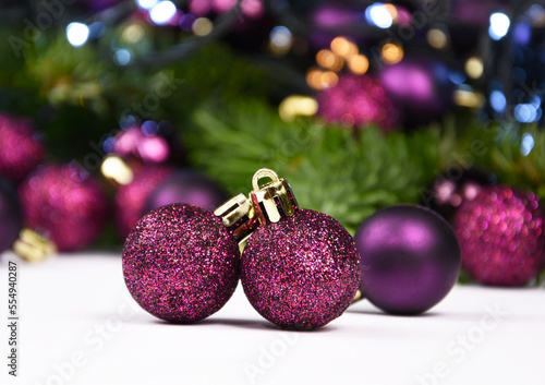 Beautiful purple Christmas glitter balls and light Christmas garland stock images. Purple baubles decoration with lights still life stock photo. Purple shiny christmas ornament image