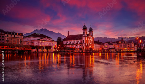 Colorful evening view of the Old Town medieval architecture in Lucerne, Switzerland. Dramatic scene with Reuss river, Jesuit church. Wonderful vivid cityscape during sunset. popular travel destination © jenyateua