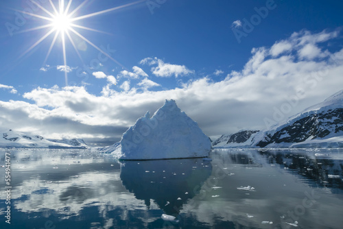 Reflections of icebergs on water in Niko Harbor, Antarctica. photo