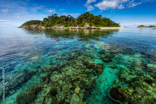 Scenic seascape of coral surrounding a tropical island. photo