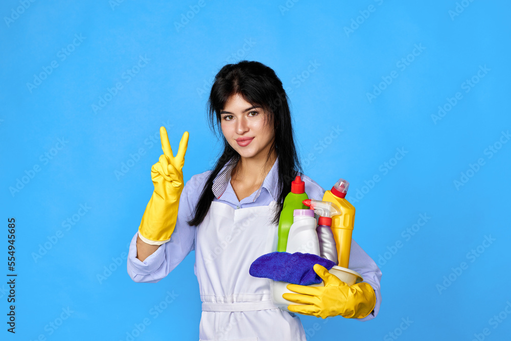 woman in gloves holding bucket of detergents and showing Ok gesture woman in gloves holding bucket of detergents and showing Ok gesture