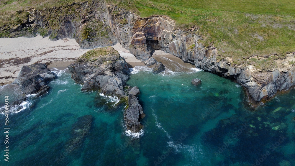 Rocky shores of the Celtic Sea along the route of the Wild Atlantic Way, top view. Seascape of the southern coast of Ireland. Beautiful rocky slopes. Drone photo. View from above. Rocky shores of the Celtic Sea along the route of the Wild Atlantic Way, top view. Seascape of the southern coast of Ireland. Beautiful rocky slopes. Drone photo. View from above.
