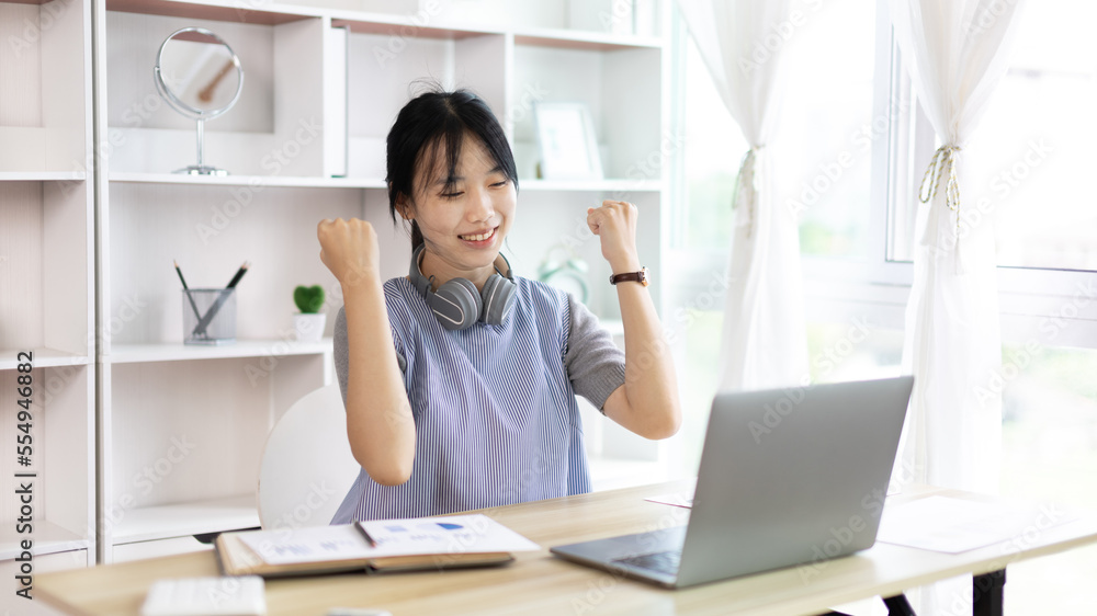 Joyful, Surprised or shocked Asian woman raised her arms all the way because she did a good job the boss gave her a big bonus making her very happy, Raise your hand, Smiling and screaming for success. Joyful, Surprised or shocked Asian woman raised her arms all the way because she did a good job the boss gave her a big bonus making her very happy, Raise your hand, Smiling and screaming for success.