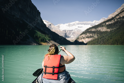 overweight woman paddling on lake  © Cody