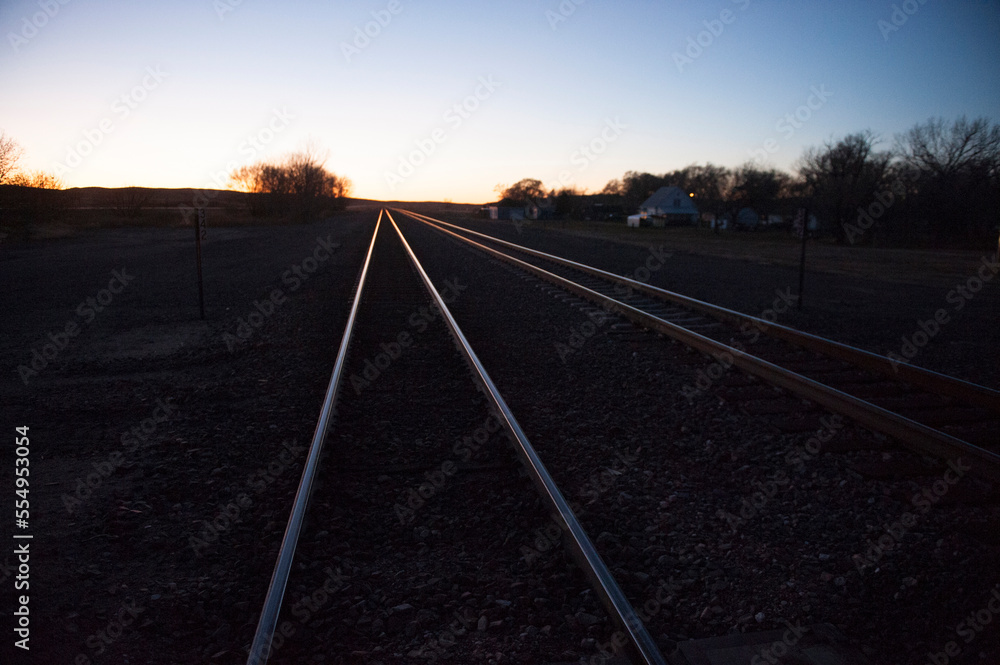 Train tracks leading into the horizon at sunset; Lakeside, Nebraska, United States of America Train tracks leading into the horizon at sunset; Lakeside, Nebraska, United States of America