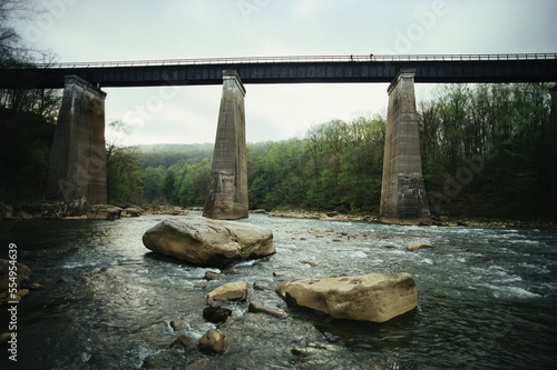 Cyclists on a bridge above the Youghiogheny River, Ohiopyle State Park, Pennsylvania, USA; Pennsylvania, United States of America photo