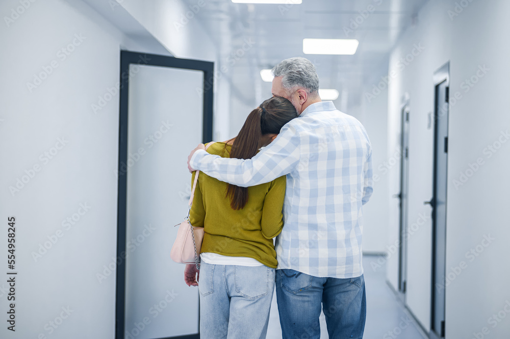 A couple in the clinic corridor after diagnostic procedure