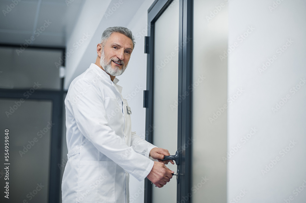 Mature male doctor locking his office Mature male doctor locking his office