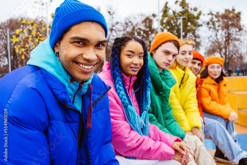 Multiracial group of young friends meeting outdoors in winter