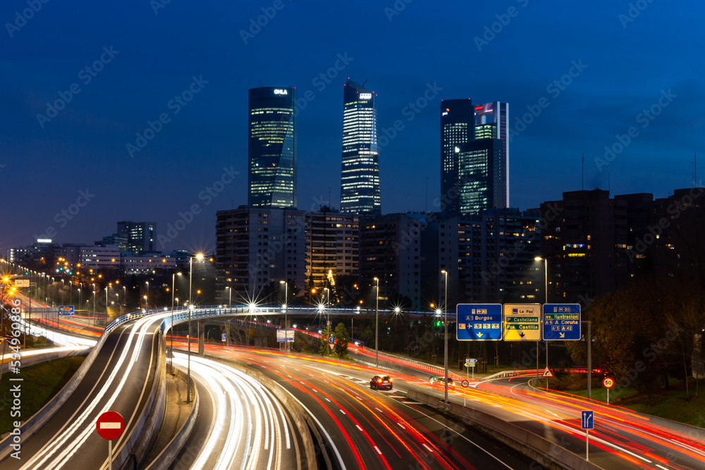  Night photo of the 4 towers in Madrid. Night photo of urban traffic with illuminated buildings.