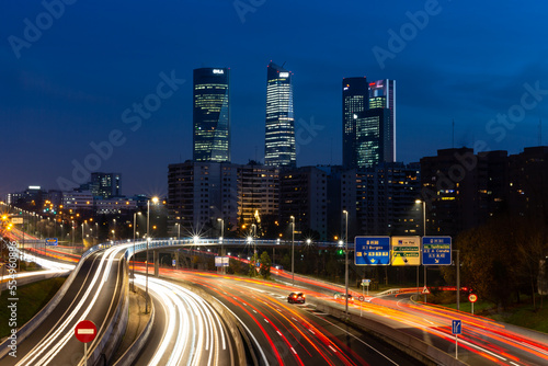  Night photo of the 4 towers in Madrid. Night photo of urban traffic with illuminated buildings. © marta