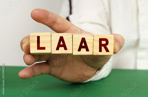 In the man's hand are cubes with the inscription - LAAR photo