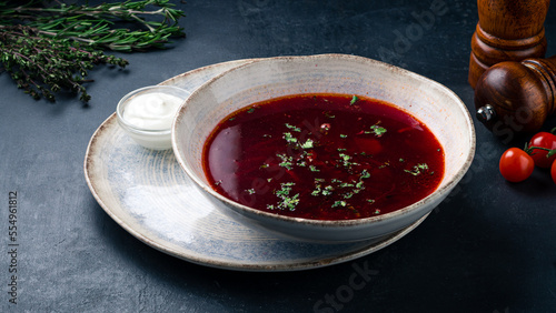 Russian red borscht soup made from beets, potatoes, cabbage, onions and greens with sour cream.